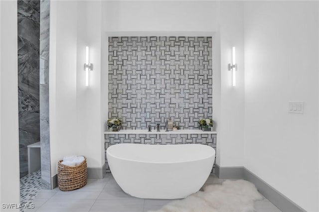 bathroom with tile walls, tile patterned flooring, and a tub