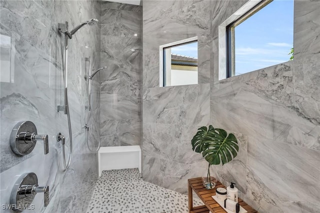 bathroom with tile walls and tiled shower