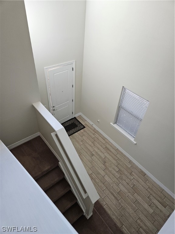 stairway with dark hardwood / wood-style flooring