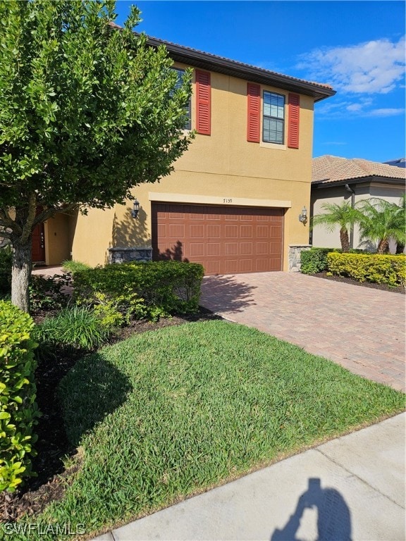 view of front of property with a front lawn and a garage