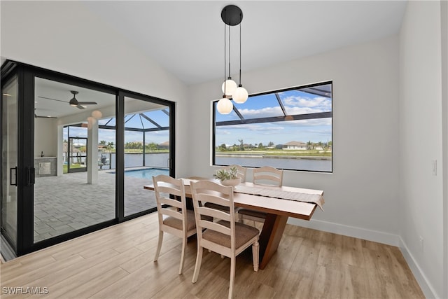 dining space featuring lofted ceiling, light hardwood / wood-style flooring, and ceiling fan