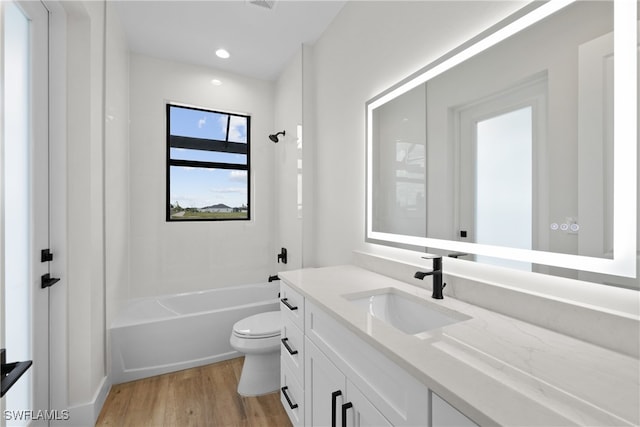 full bathroom with shower / bathing tub combination, vanity, toilet, and hardwood / wood-style flooring