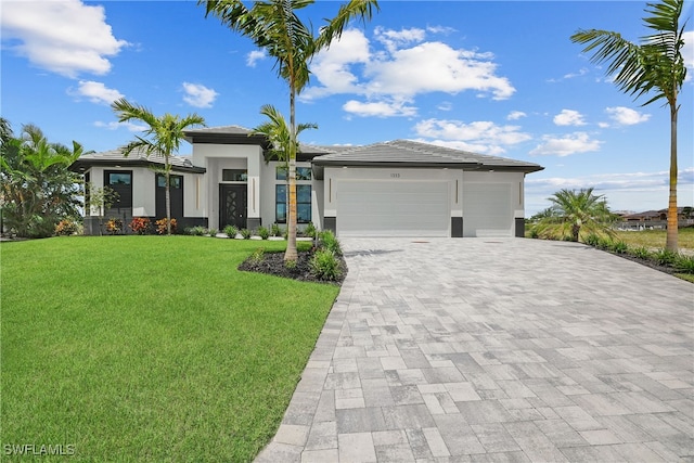 view of front of home with a front yard and a garage