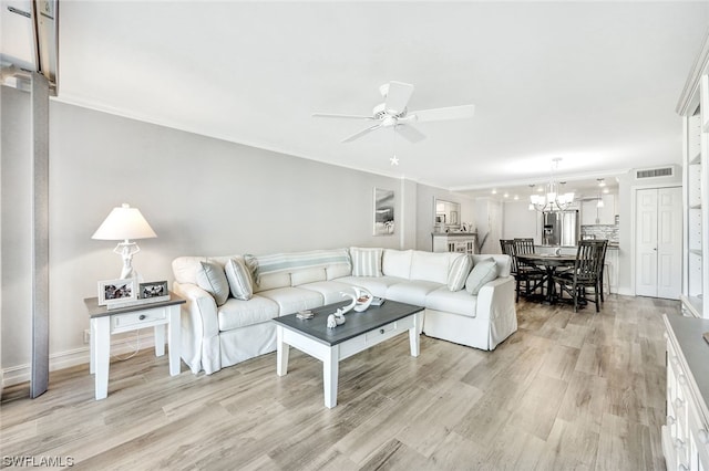 living room featuring crown molding, light hardwood / wood-style floors, and ceiling fan with notable chandelier