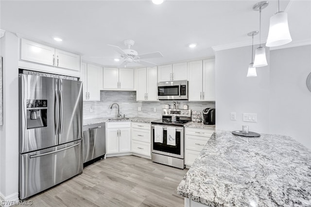 kitchen featuring ceiling fan, hanging light fixtures, stainless steel appliances, white cabinetry, and light wood-type flooring