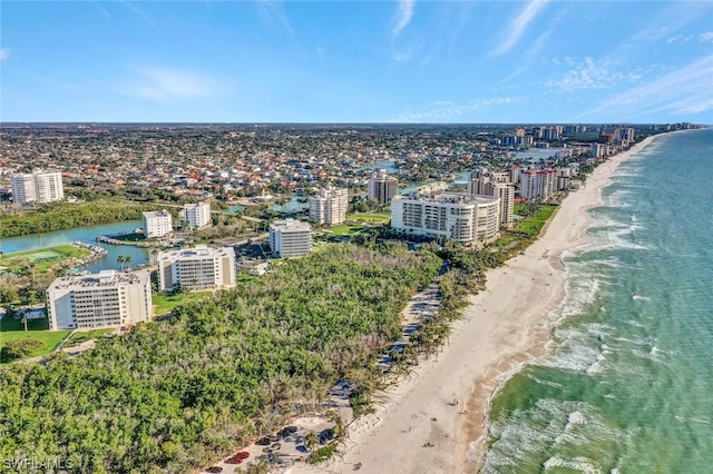 aerial view with a water view and a beach view