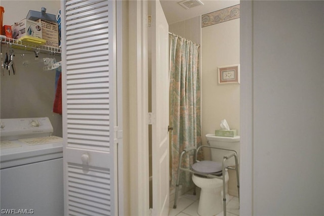 bathroom with vanity, tile flooring, washer / dryer, and toilet