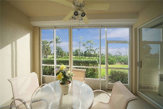 sunroom featuring ceiling fan