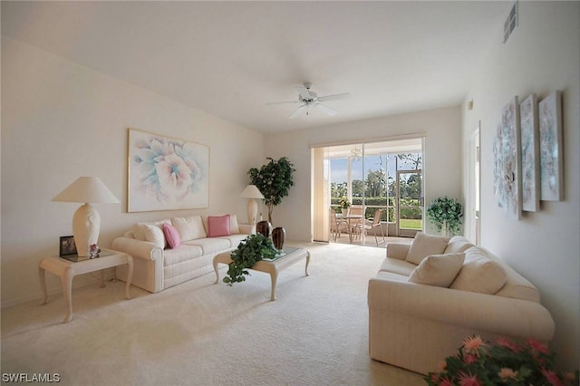 carpeted living room with ceiling fan