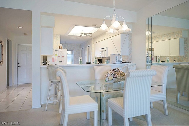 dining room featuring light tile floors and a chandelier