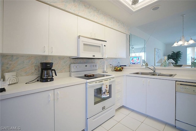 kitchen with light tile floors, white appliances, white cabinetry, sink, and an inviting chandelier