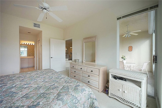 tiled bedroom with connected bathroom and ceiling fan