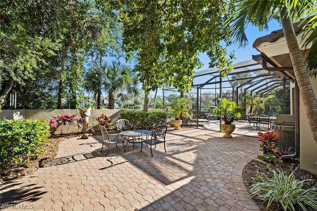 view of patio featuring a lanai