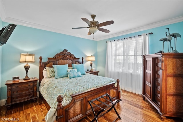 bedroom featuring ornamental molding, ceiling fan, and light hardwood / wood-style flooring