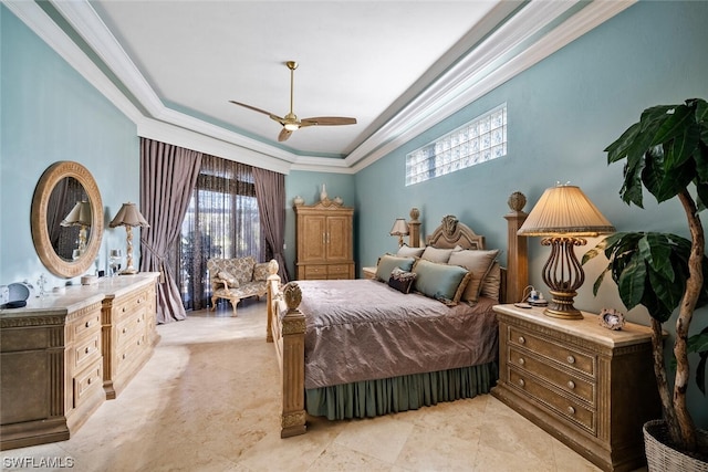 tiled bedroom featuring crown molding, ceiling fan, a tray ceiling, and multiple windows