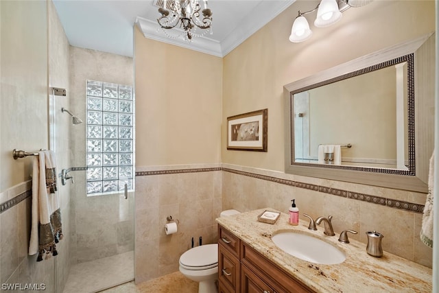 bathroom featuring tile walls, toilet, vanity, and an inviting chandelier