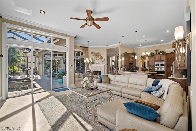 living room featuring ceiling fan with notable chandelier and ornamental molding