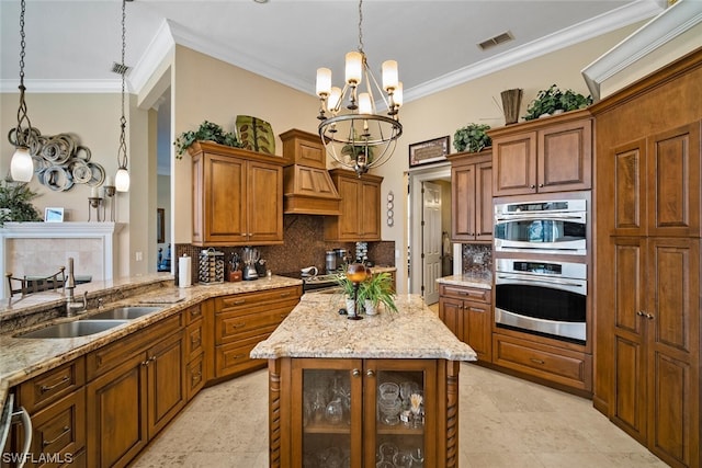 kitchen with decorative light fixtures, backsplash, double oven, a notable chandelier, and sink