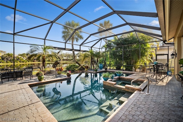 view of pool with a patio area, an in ground hot tub, and a lanai