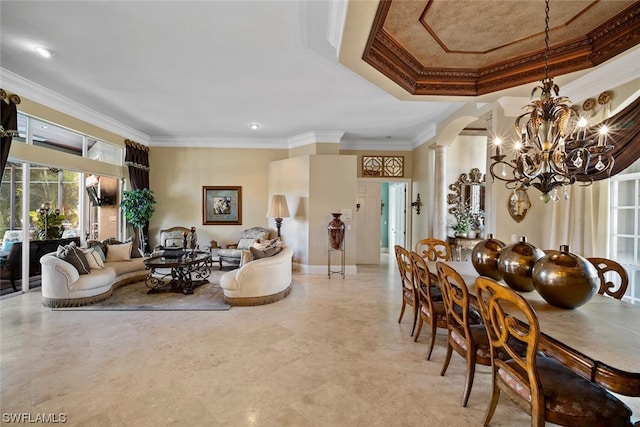 living room featuring a notable chandelier, light tile flooring, crown molding, a raised ceiling, and ornate columns