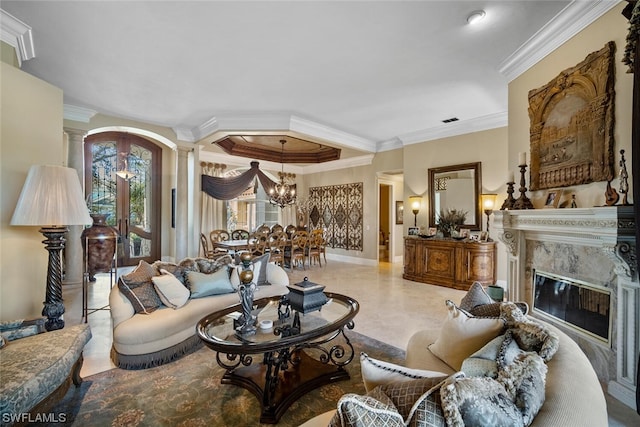 living room with light tile floors, crown molding, a fireplace, ornate columns, and an inviting chandelier