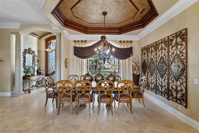 tiled dining space with crown molding, a tray ceiling, ornate columns, and an inviting chandelier