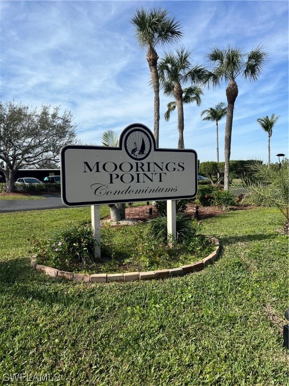 community / neighborhood sign with a lawn