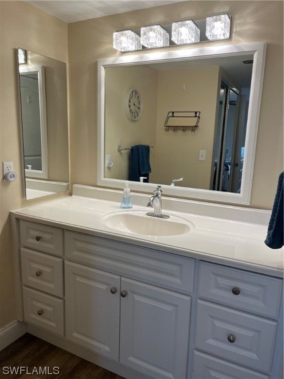 bathroom featuring vanity and wood-type flooring