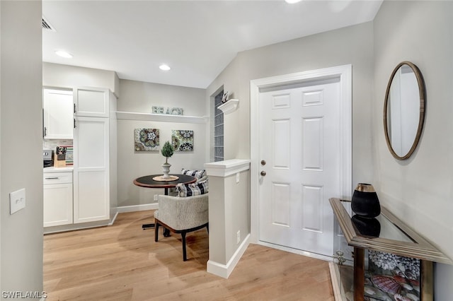 foyer entrance with light hardwood / wood-style flooring