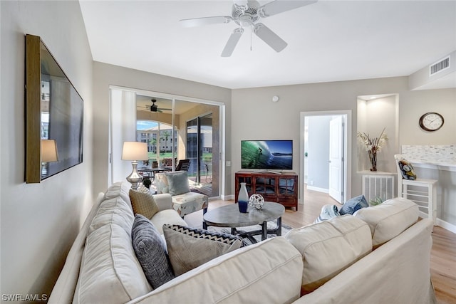 living room with ceiling fan and light hardwood / wood-style floors