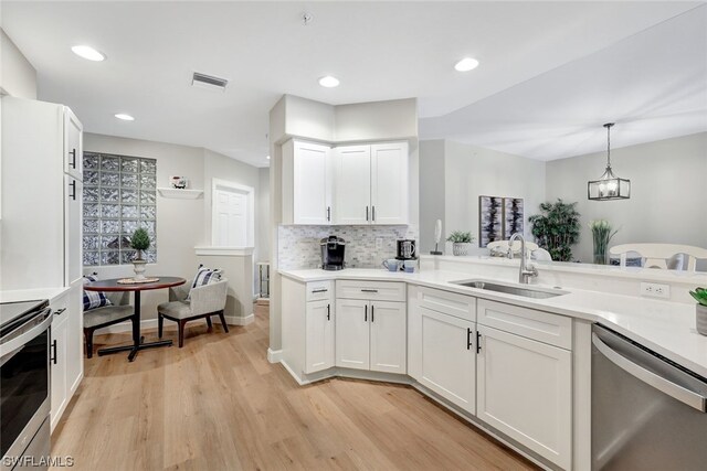 kitchen featuring stainless steel appliances, sink, and white cabinets