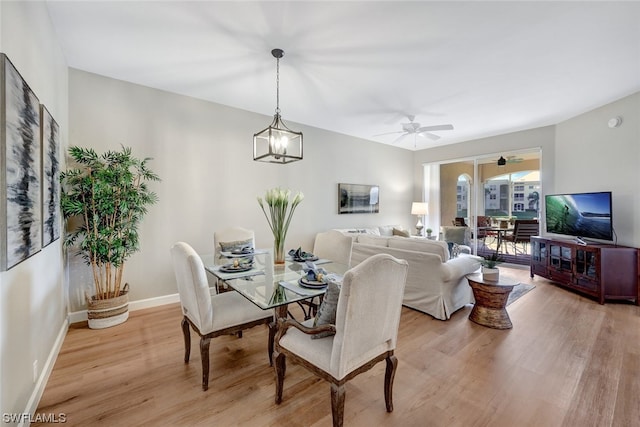 dining space featuring ceiling fan and light wood-type flooring