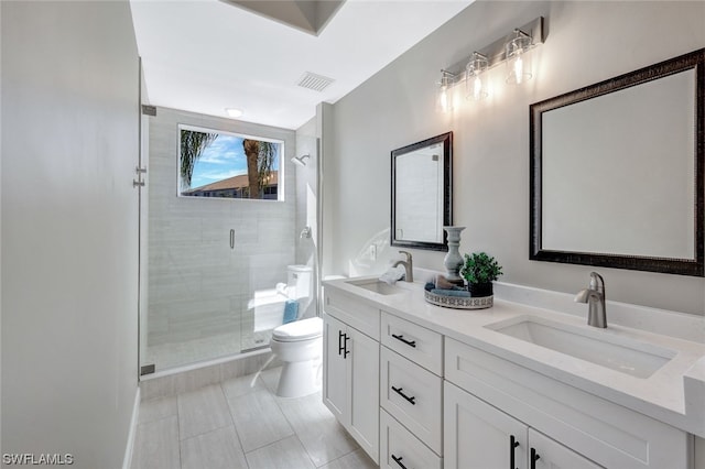 bathroom with vanity, toilet, and an enclosed shower