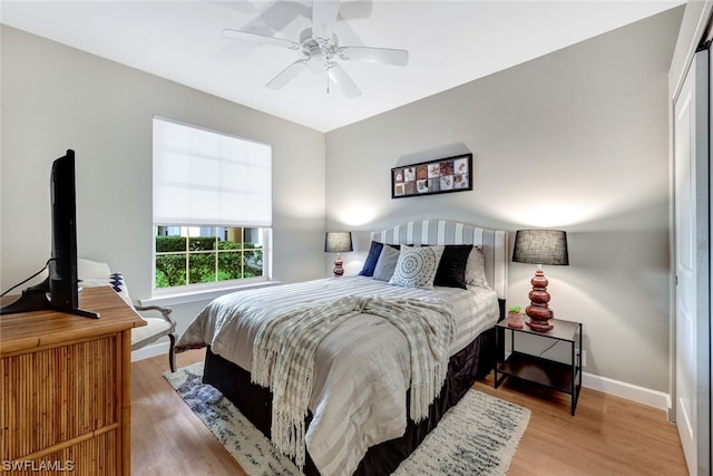 bedroom with ceiling fan and light hardwood / wood-style floors