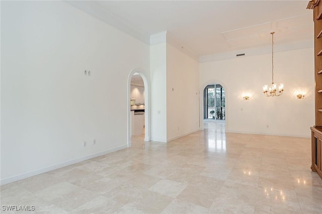 empty room with a notable chandelier and ornamental molding