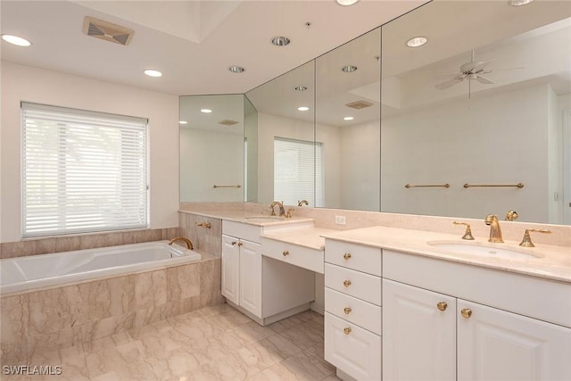 bathroom with vanity, ceiling fan, and a relaxing tiled tub