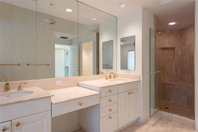 bathroom featuring tiled shower, ceiling fan, and vanity