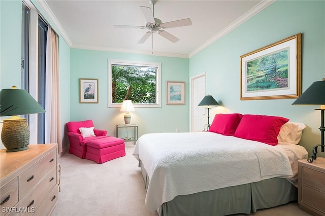 carpeted bedroom featuring ceiling fan and crown molding