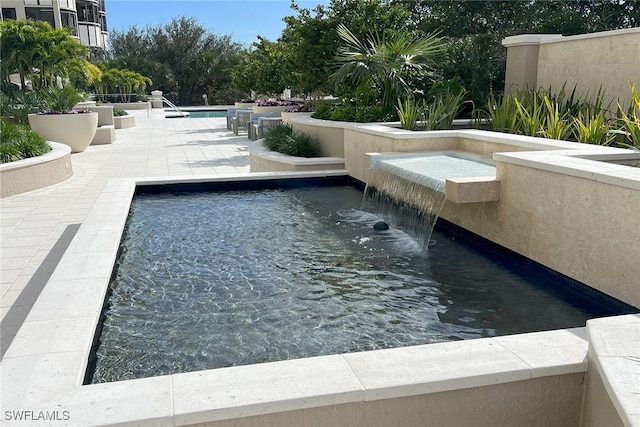 view of swimming pool featuring a patio and pool water feature