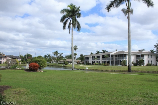 view of property's community featuring a water view and a yard