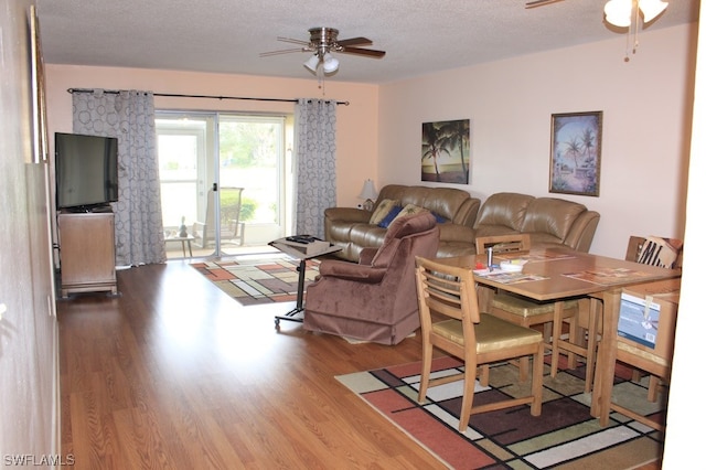 dining room featuring hardwood / wood-style floors, a textured ceiling, and ceiling fan