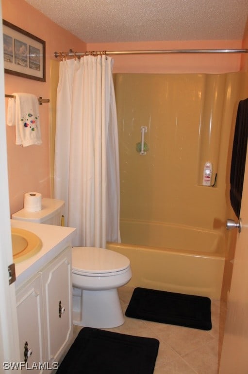 full bathroom featuring toilet, shower / bath combo with shower curtain, a textured ceiling, vanity, and tile floors