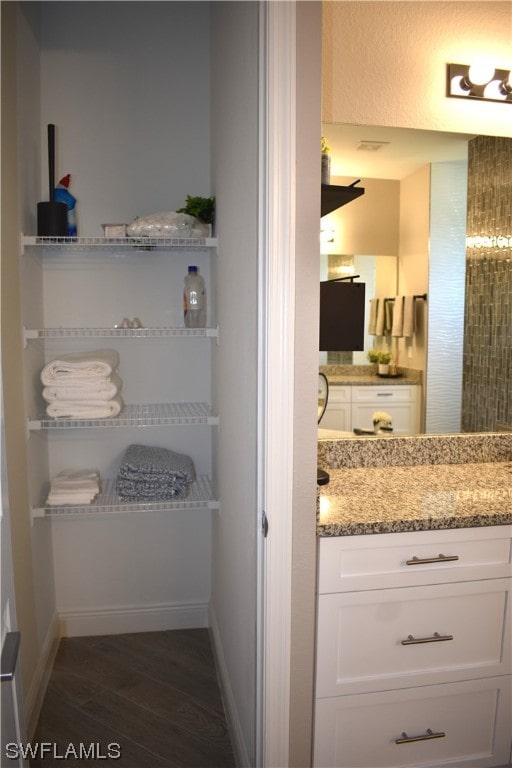 bathroom with vanity and wood-type flooring