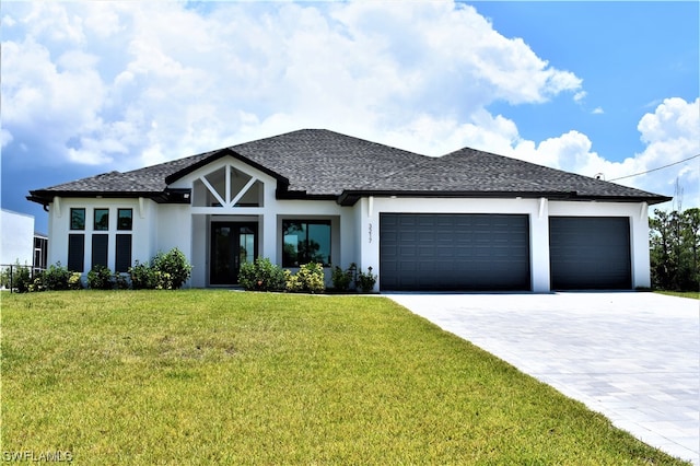 view of front of property featuring a front lawn and a garage