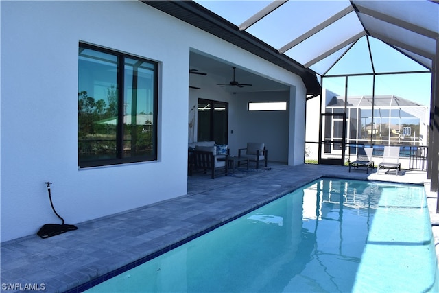 view of pool featuring ceiling fan, a lanai, and a patio area