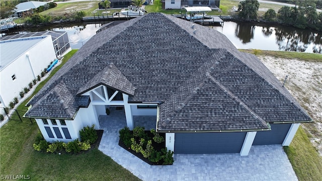 birds eye view of property with a water view