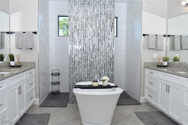 bathroom with vanity, tile walls, and plus walk in shower