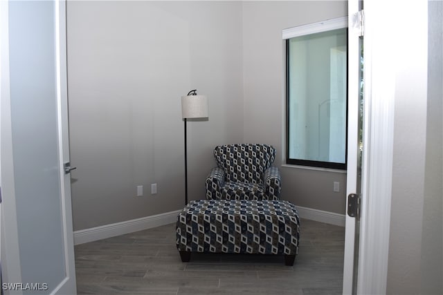 sitting room with dark wood-type flooring