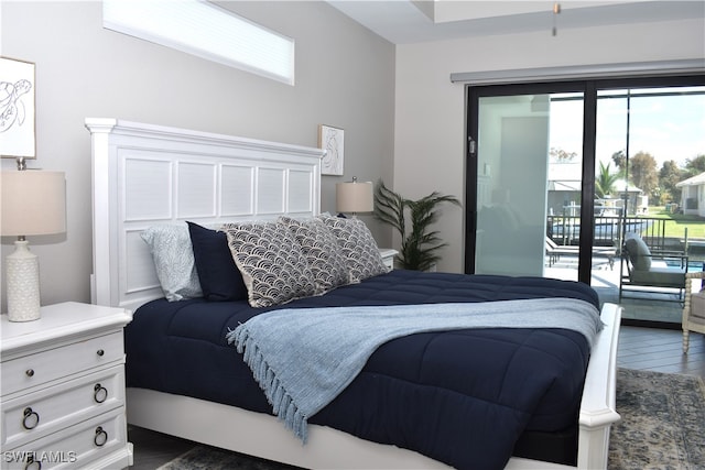 bedroom featuring access to outside and dark hardwood / wood-style floors