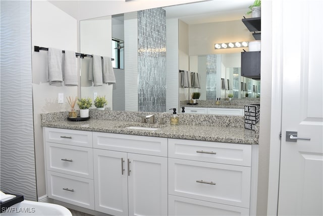 bathroom with vanity and a shower